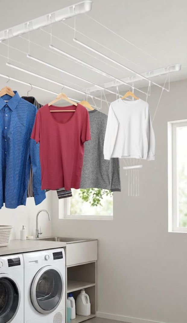 White Practic Drop Dryer mounted on a laundry room ceiling with shirts drying on hangers overhead